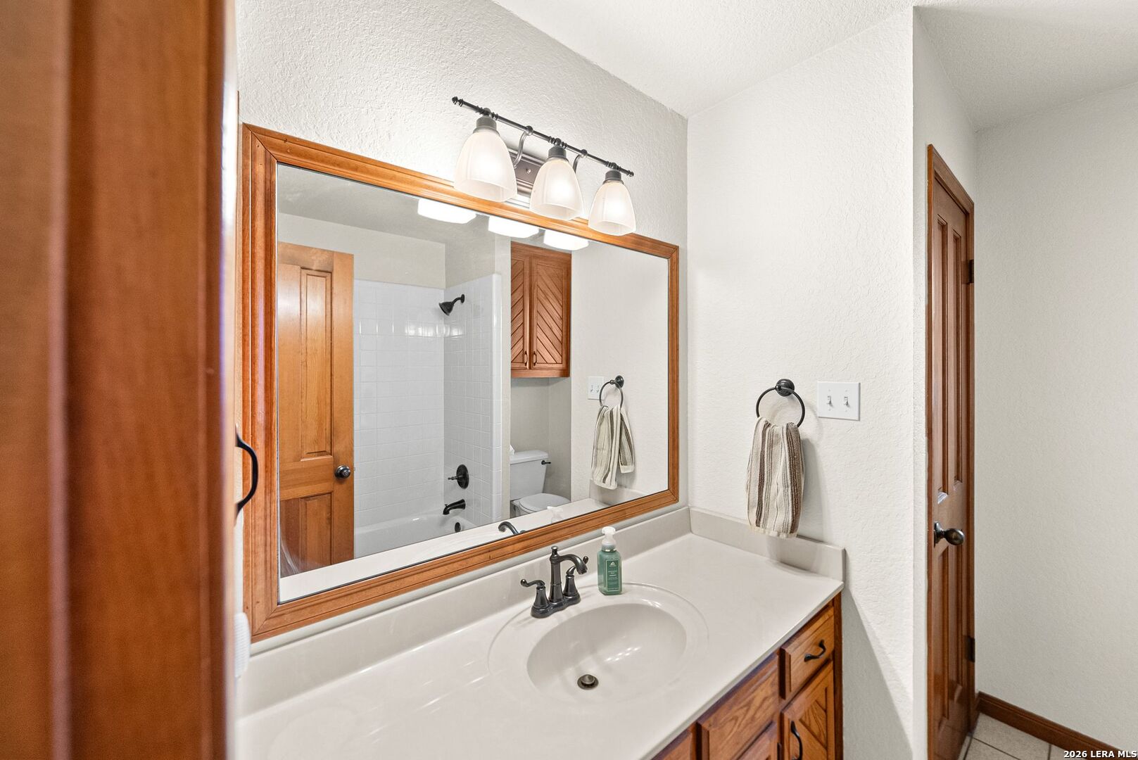 14320 La Vernia Road St. Hedwig, TX 78152 - Photo 28 of 71 a bathroom with a sink and a mirror