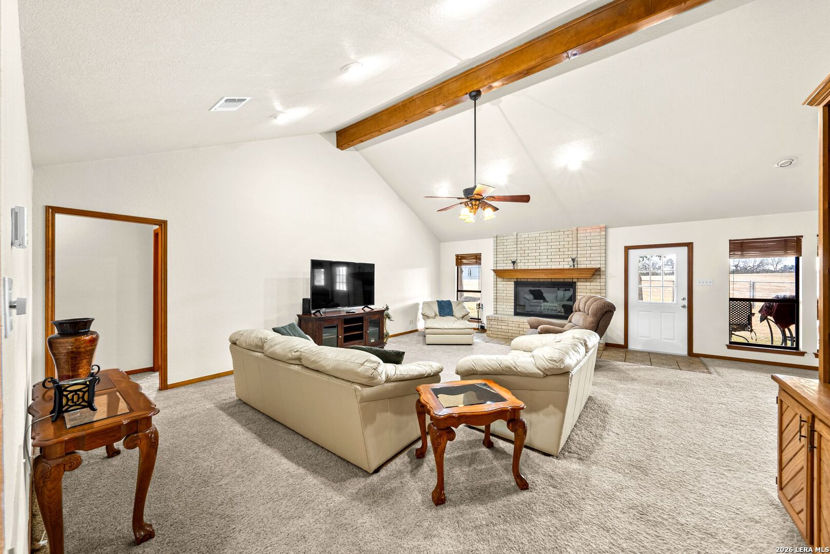 14320 La Vernia Road St. Hedwig, TX 78152 - Photo 6 of 71 a living room with furniture a fireplace and a flat screen tv