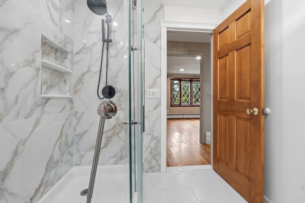 28 Spring Road Westborough, MA 01581 - Photo 15 of 42 a bathroom with a glass shower door
