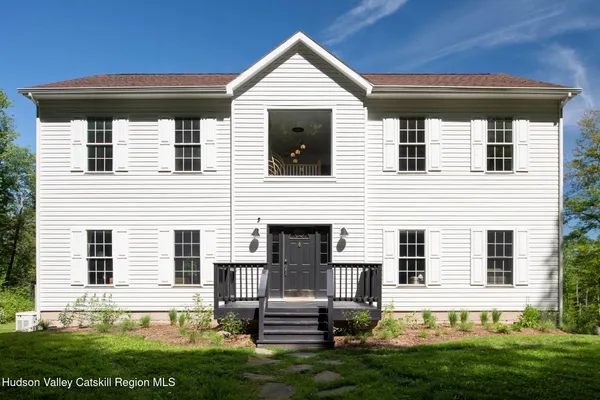 a view of house with yard