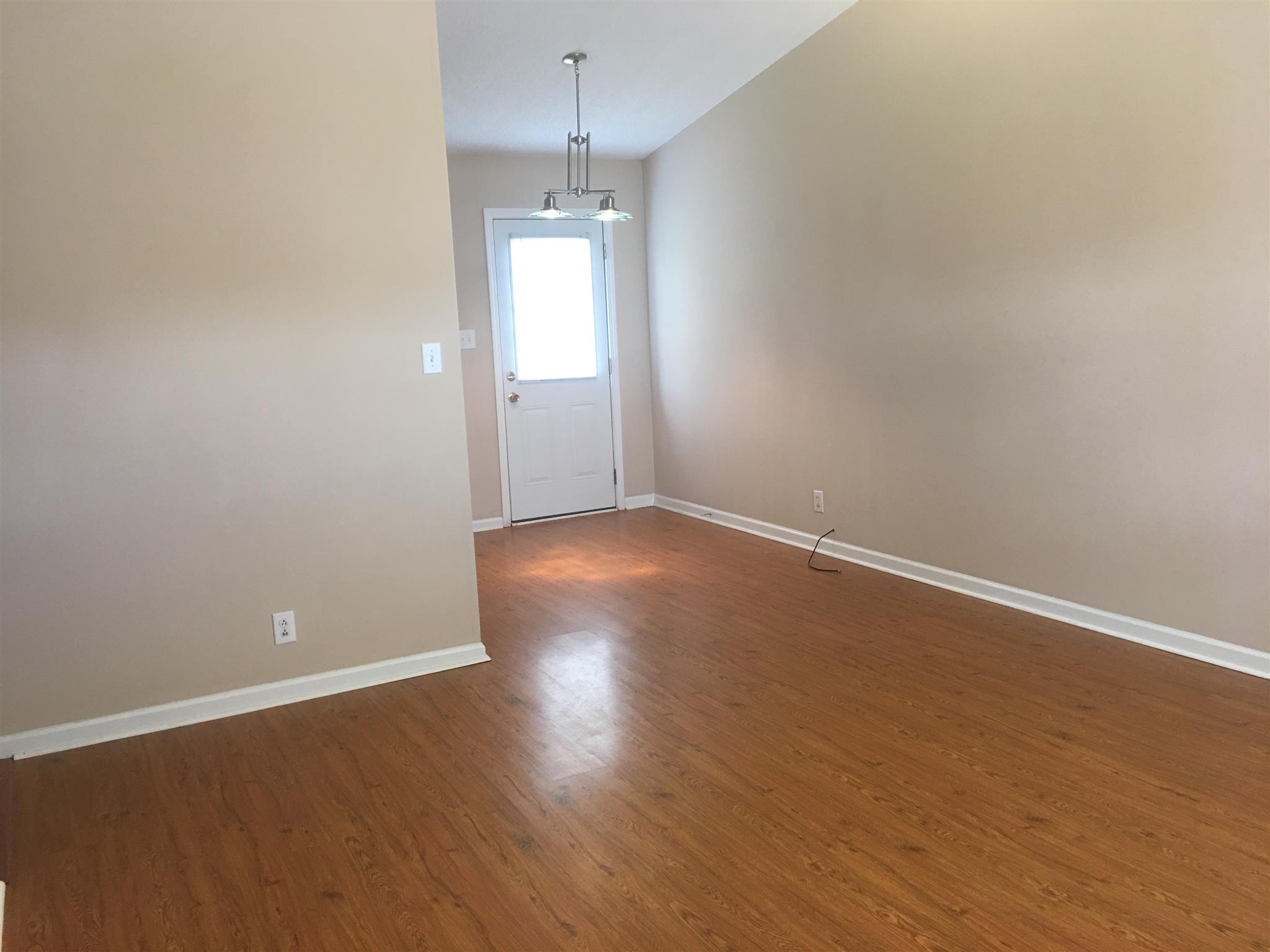 1126 Timothy Avenue Oak Grove, KY 42262 - Photo 3 of 12 an empty room with wooden floor and windows