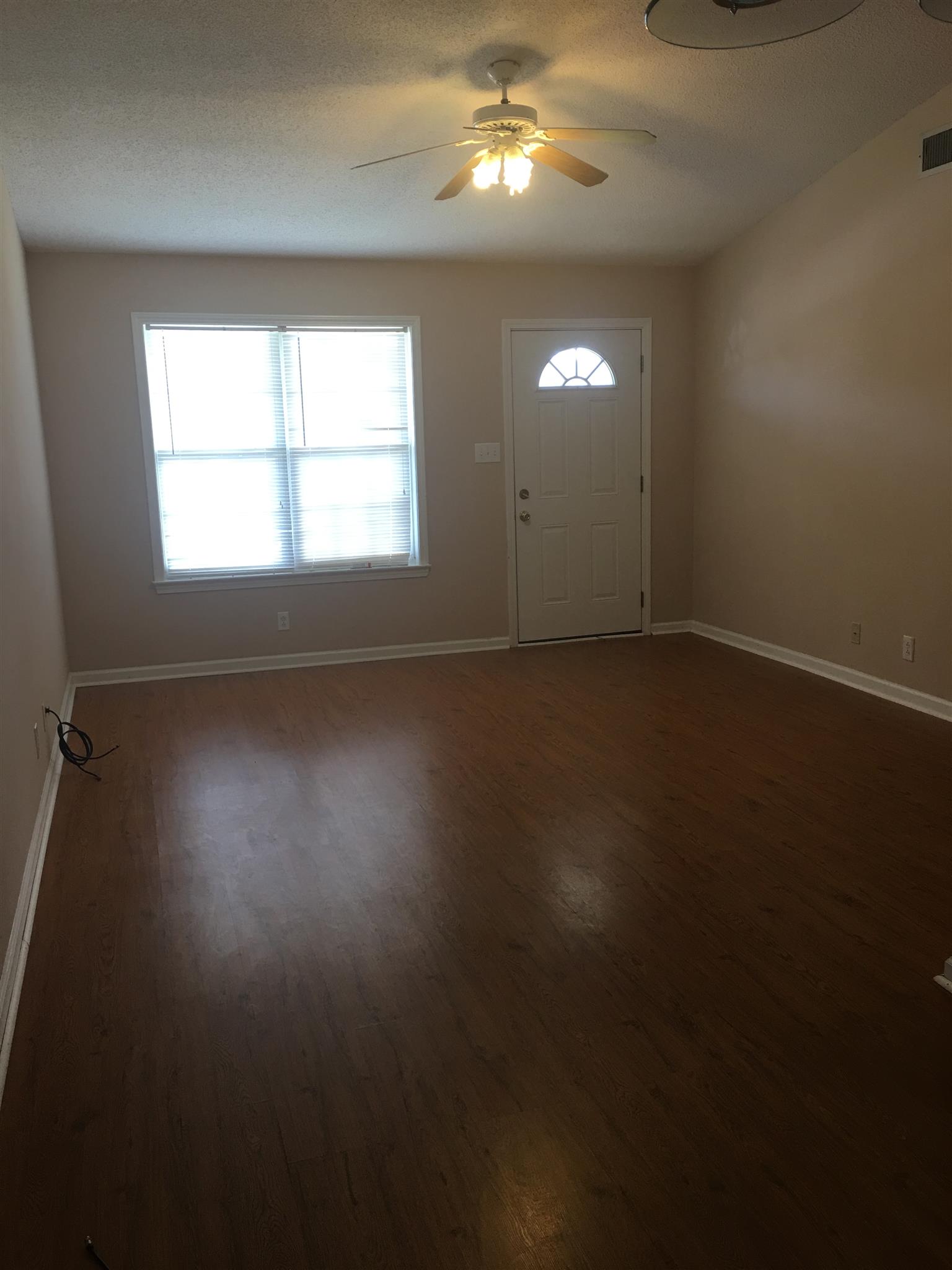 1126 Timothy Avenue Oak Grove, KY 42262 - Photo 4 of 12 an empty room with wooden floor and windows