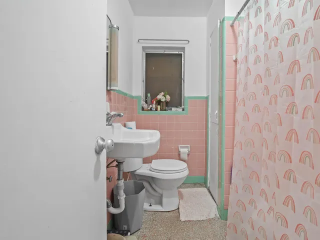 a bedroom with furniture and a chandelier fan