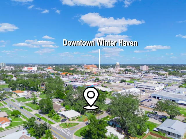 an aerial view of a house with a yard basket ball court and outdoor seating