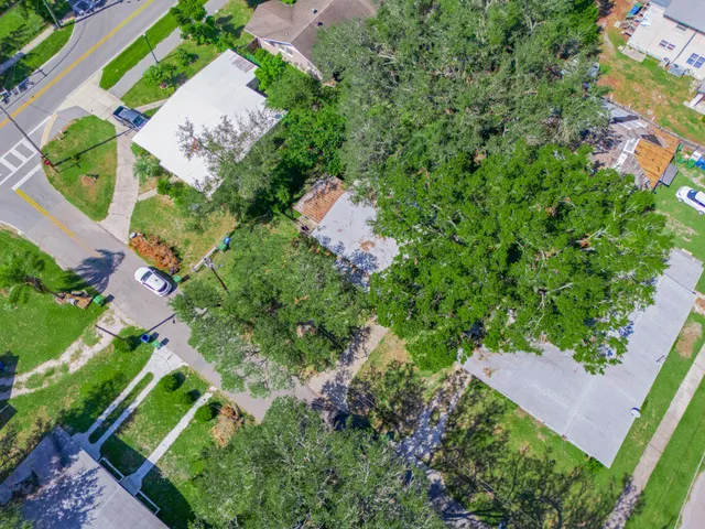 an aerial view of a house with a yard and lake view