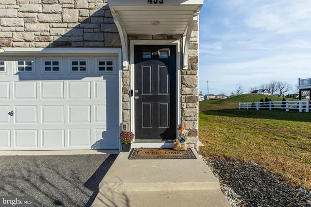a front view of a house with ocean