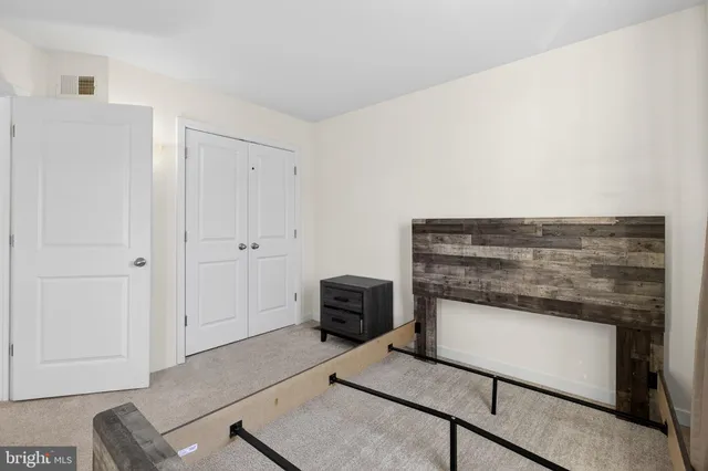 a bedroom with a bed and large window