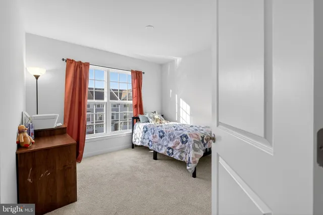 a bedroom with a bed and window