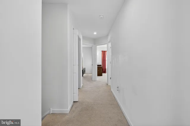 a bedroom with a bed and a flat tv screen on dresser