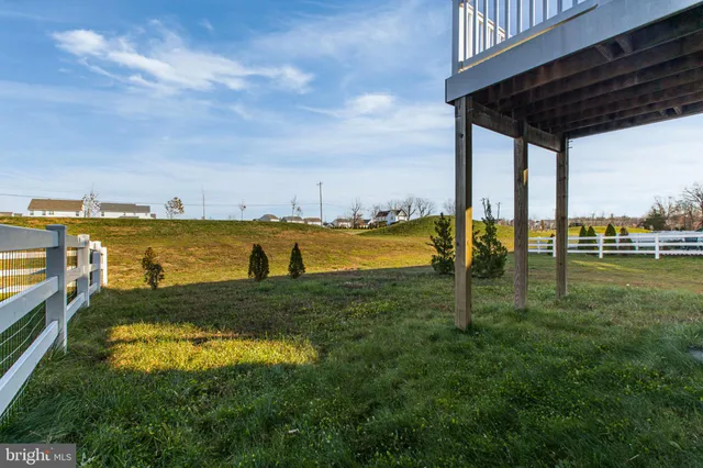 a front view of house with a garden