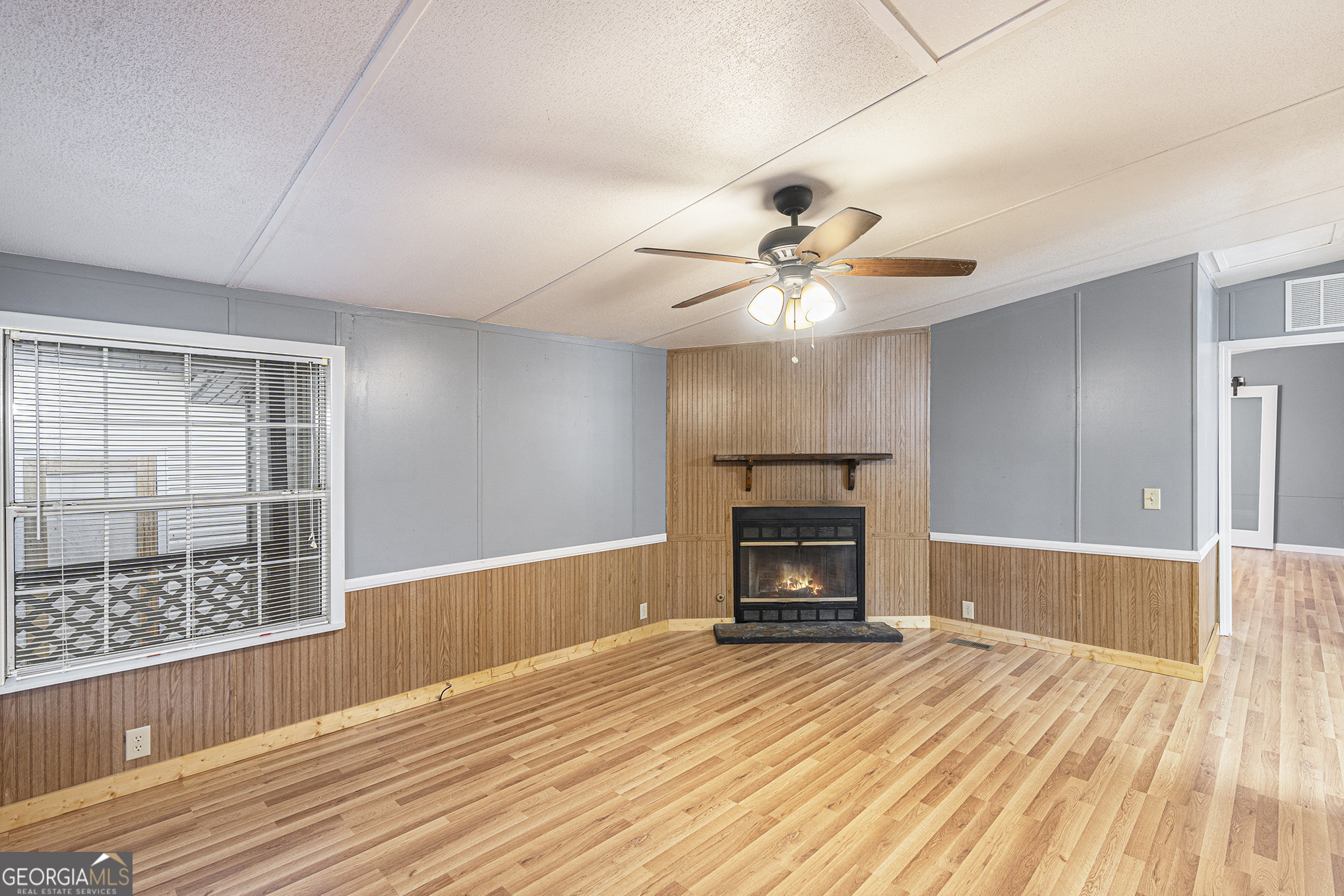 340 Loblolly Ridge Locust Grove, GA 30248 - Photo 11 of 26 a view of empty room with wooden floor and fan