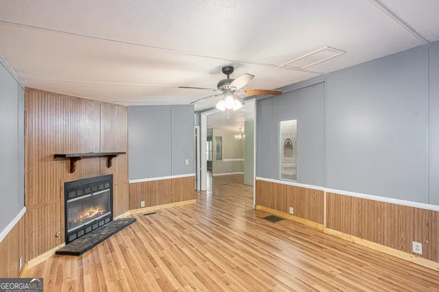 wooden floor in an empty room with a fireplace