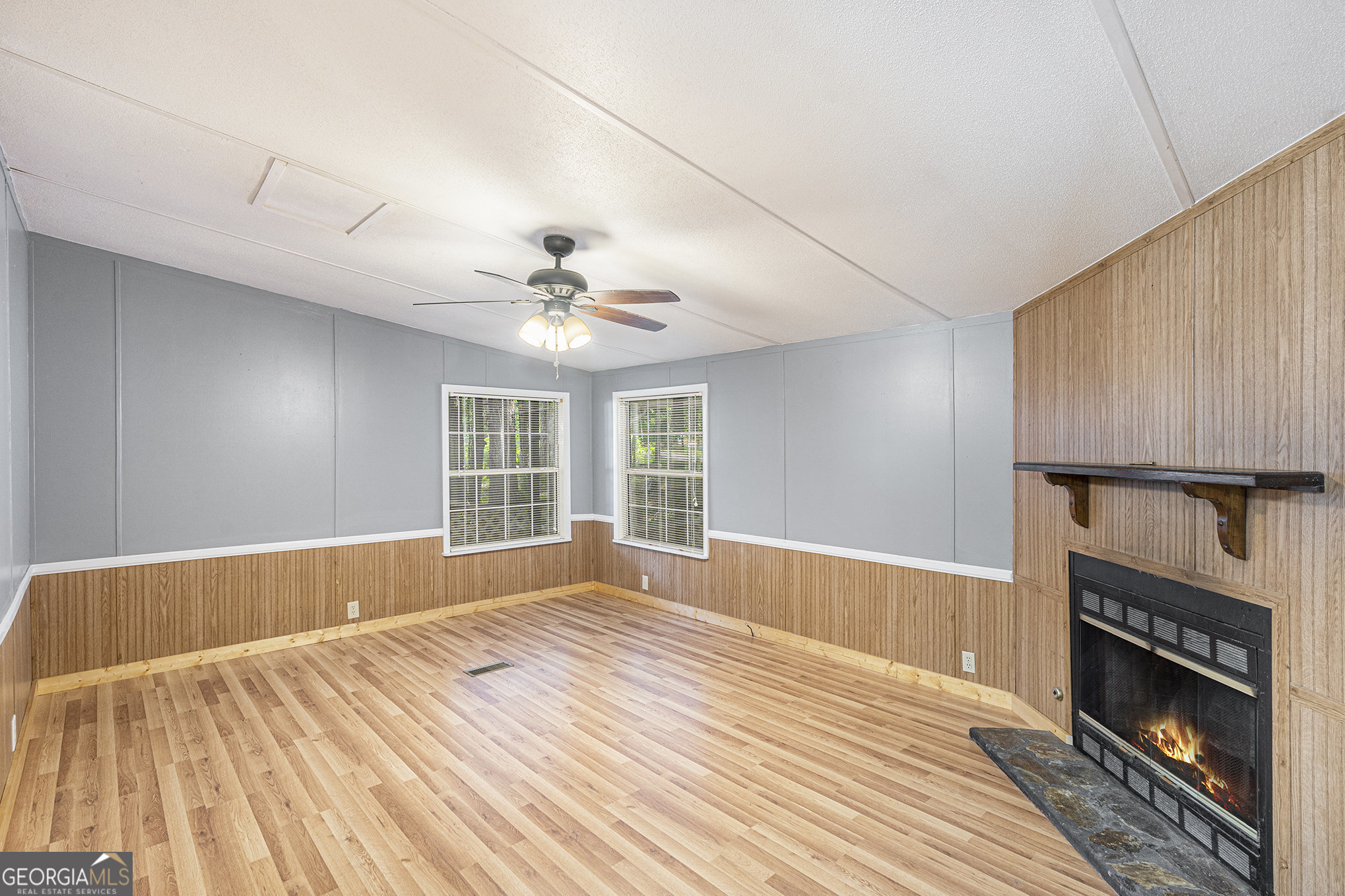 340 Loblolly Ridge Locust Grove, GA 30248 - Photo 13 of 26 a view of an empty room with wooden floor and a window