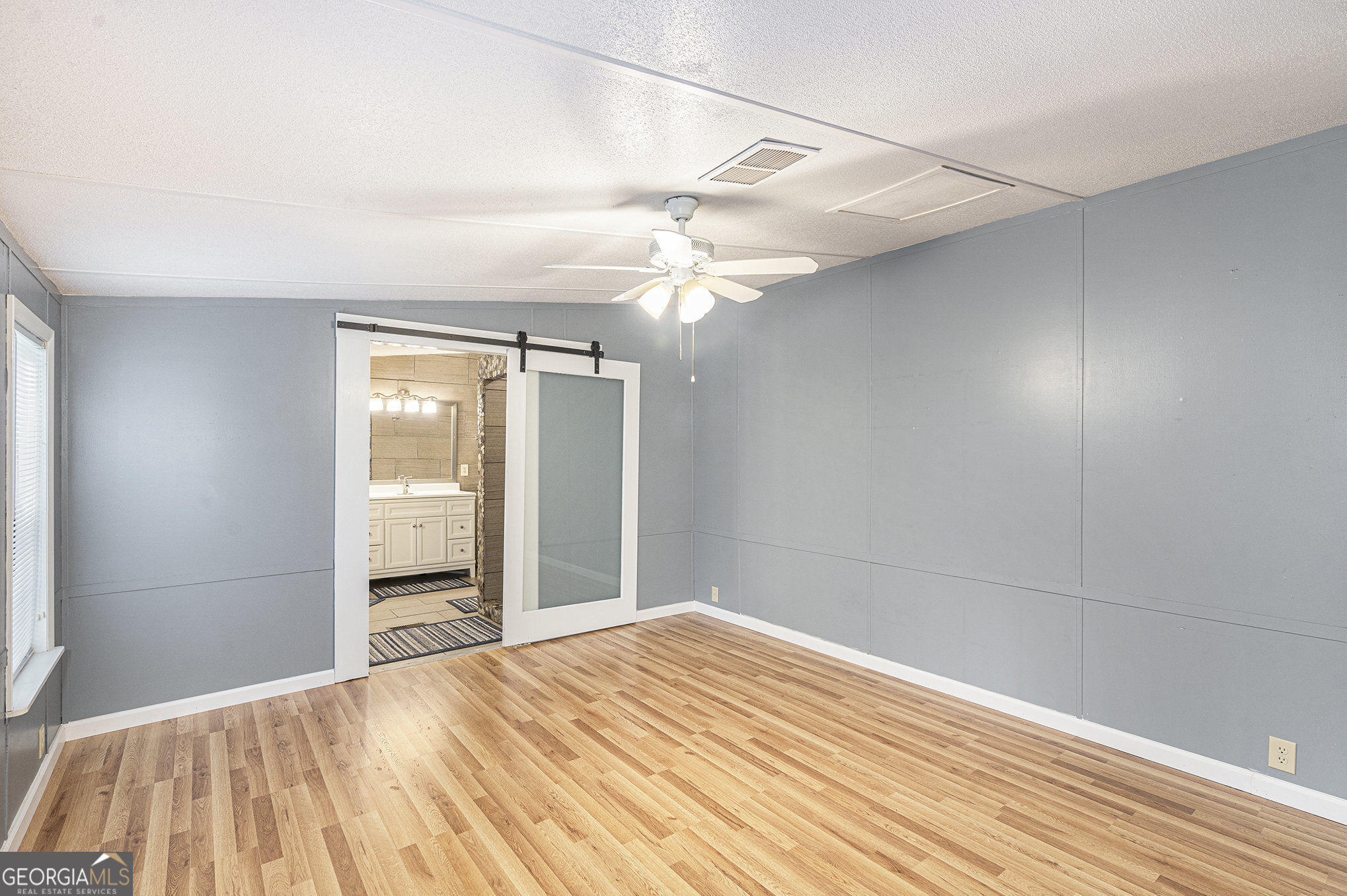 340 Loblolly Ridge Locust Grove, GA 30248 - Photo 16 of 26 a bedroom with a bed and a chandelier
