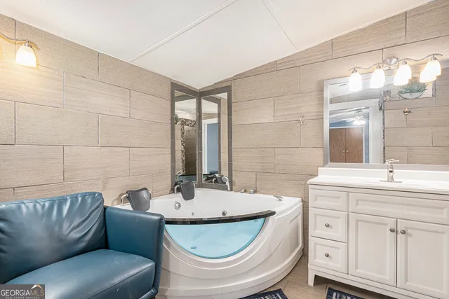 a bathroom with a granite countertop sink a toilet and a mirror