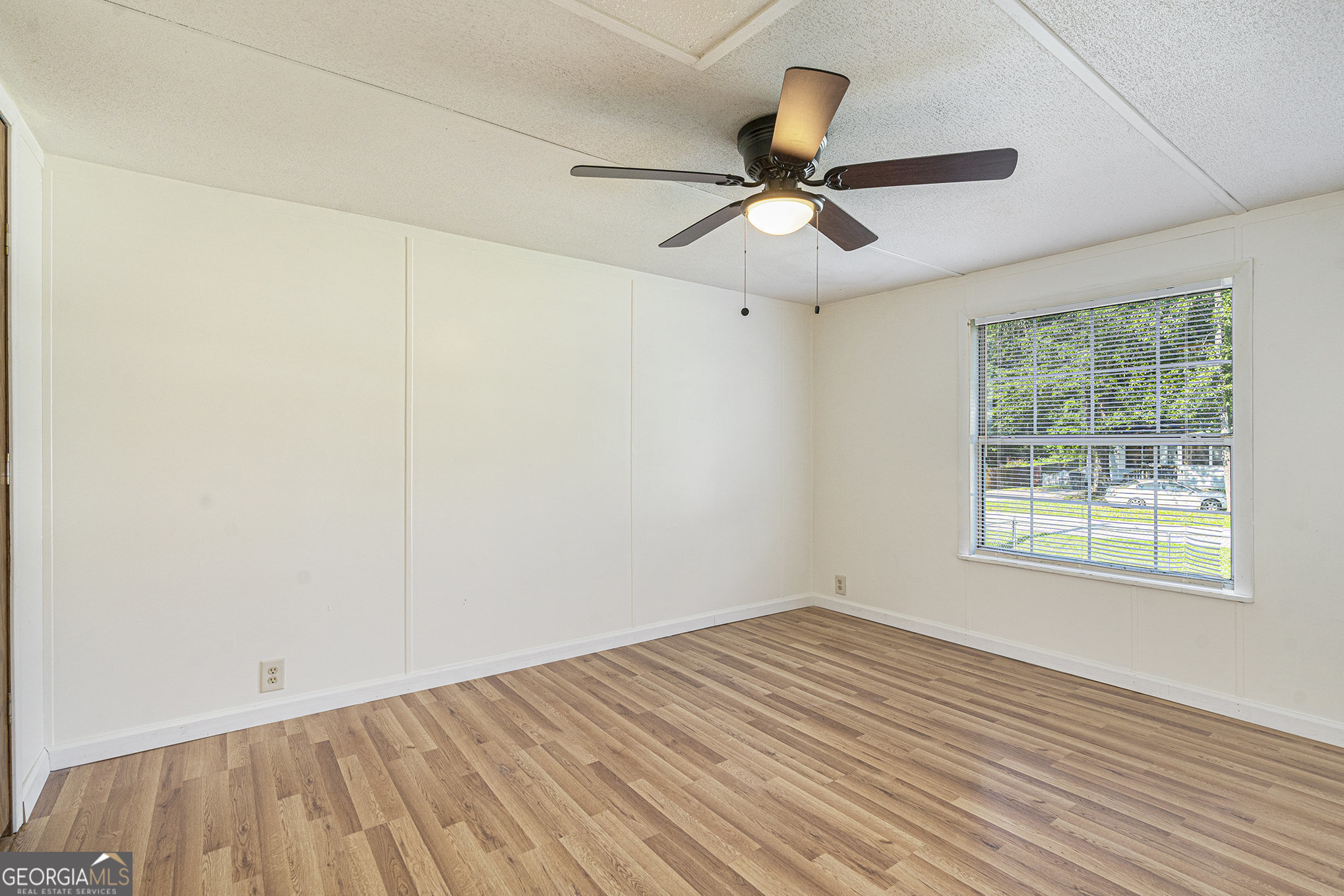 340 Loblolly Ridge Locust Grove, GA 30248 - Photo 19 of 26 a view of an empty room with wooden floor and a window