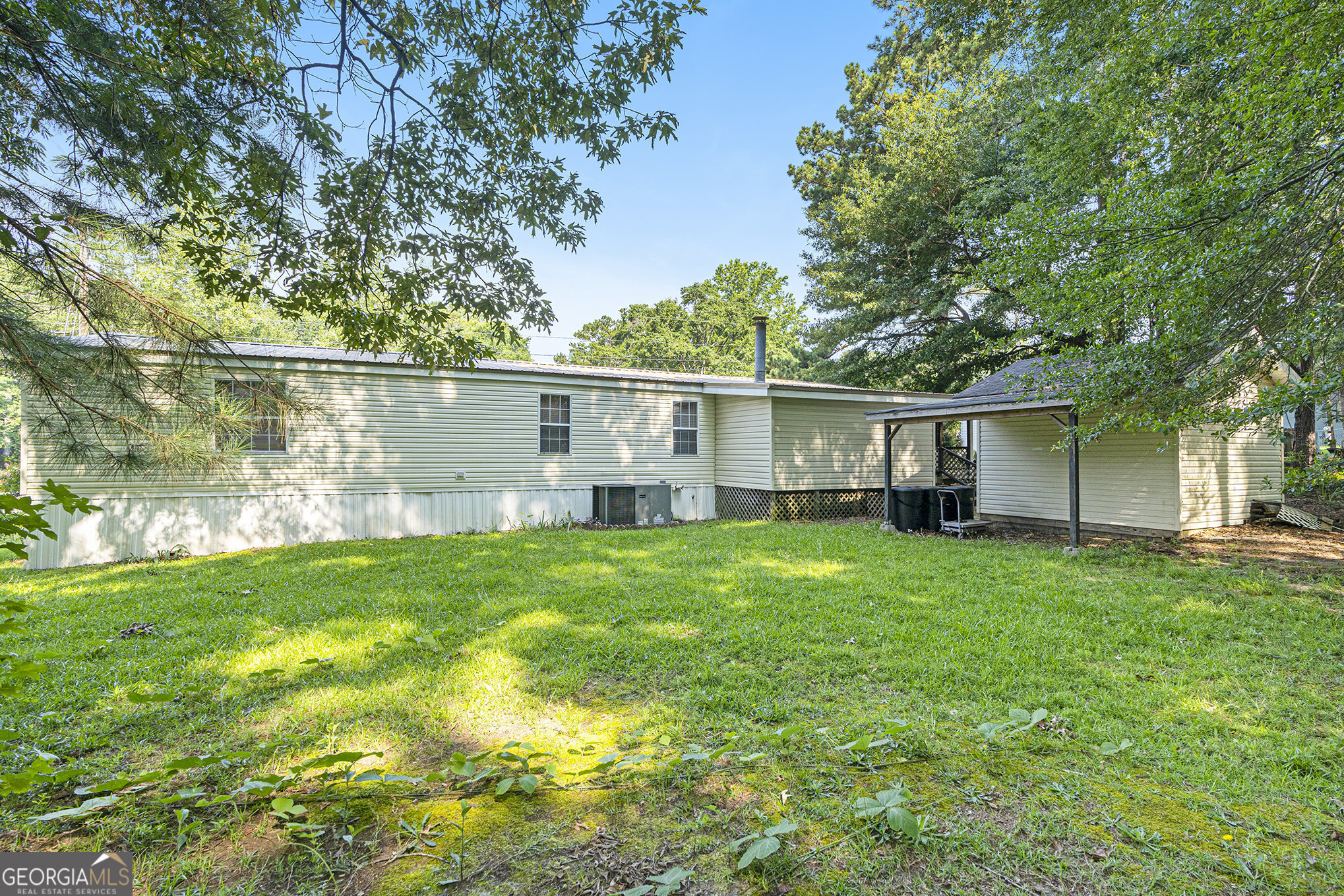 340 Loblolly Ridge Locust Grove, GA 30248 - Photo 21 of 26 a view of a backyard with plants and large trees