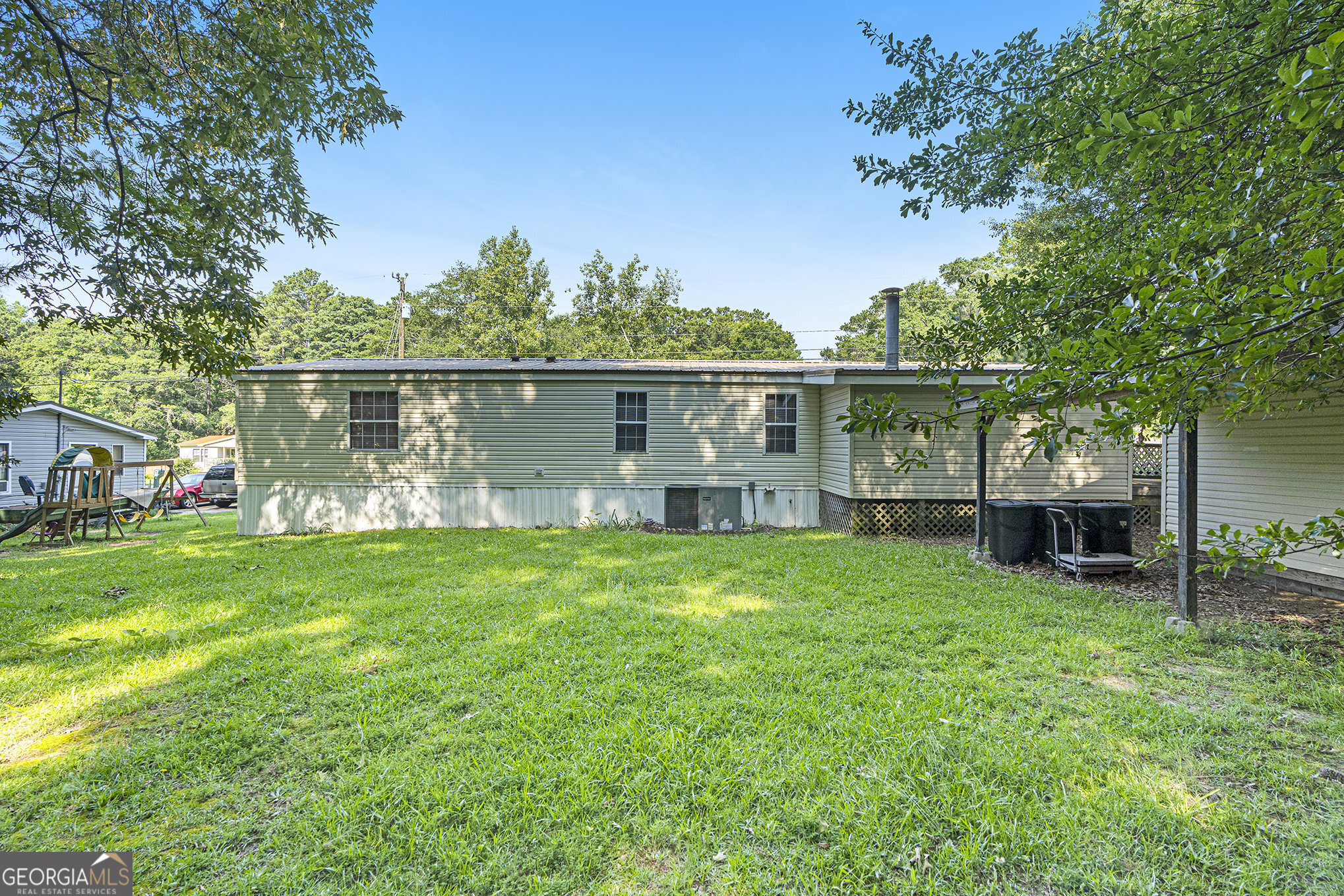 340 Loblolly Ridge Locust Grove, GA 30248 - Photo 22 of 26 a view of a backyard with a garden and trees