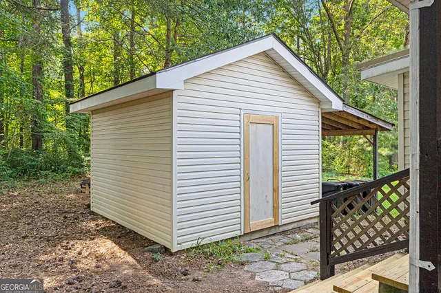 a view of a small house with a backyard space