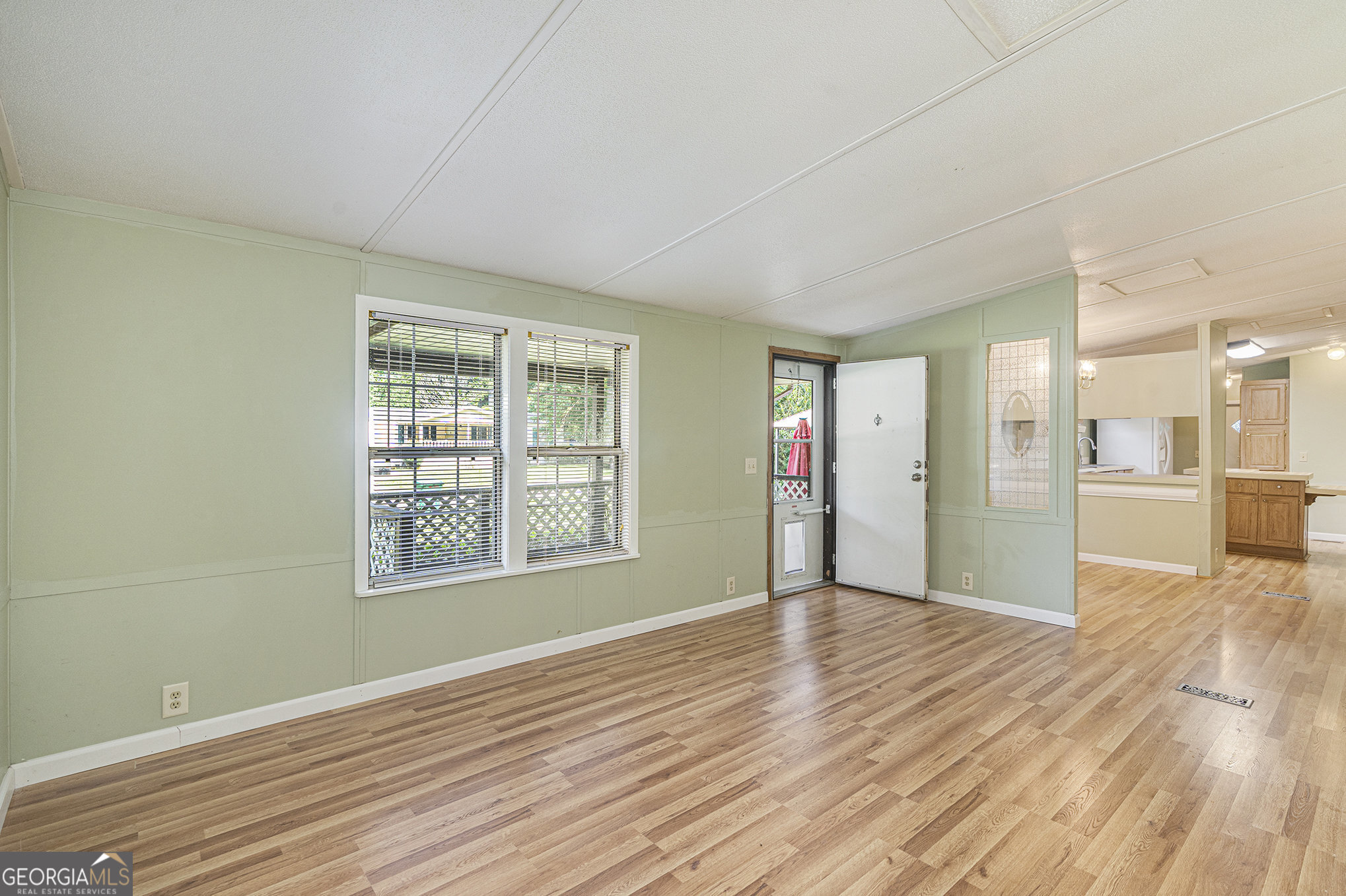 340 Loblolly Ridge Locust Grove, GA 30248 - Photo 24 of 26 a view of an empty room with wooden floor and a window