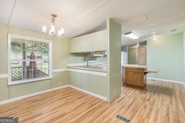 a open kitchen with kitchen island wooden floors center island and stainless steel appliances