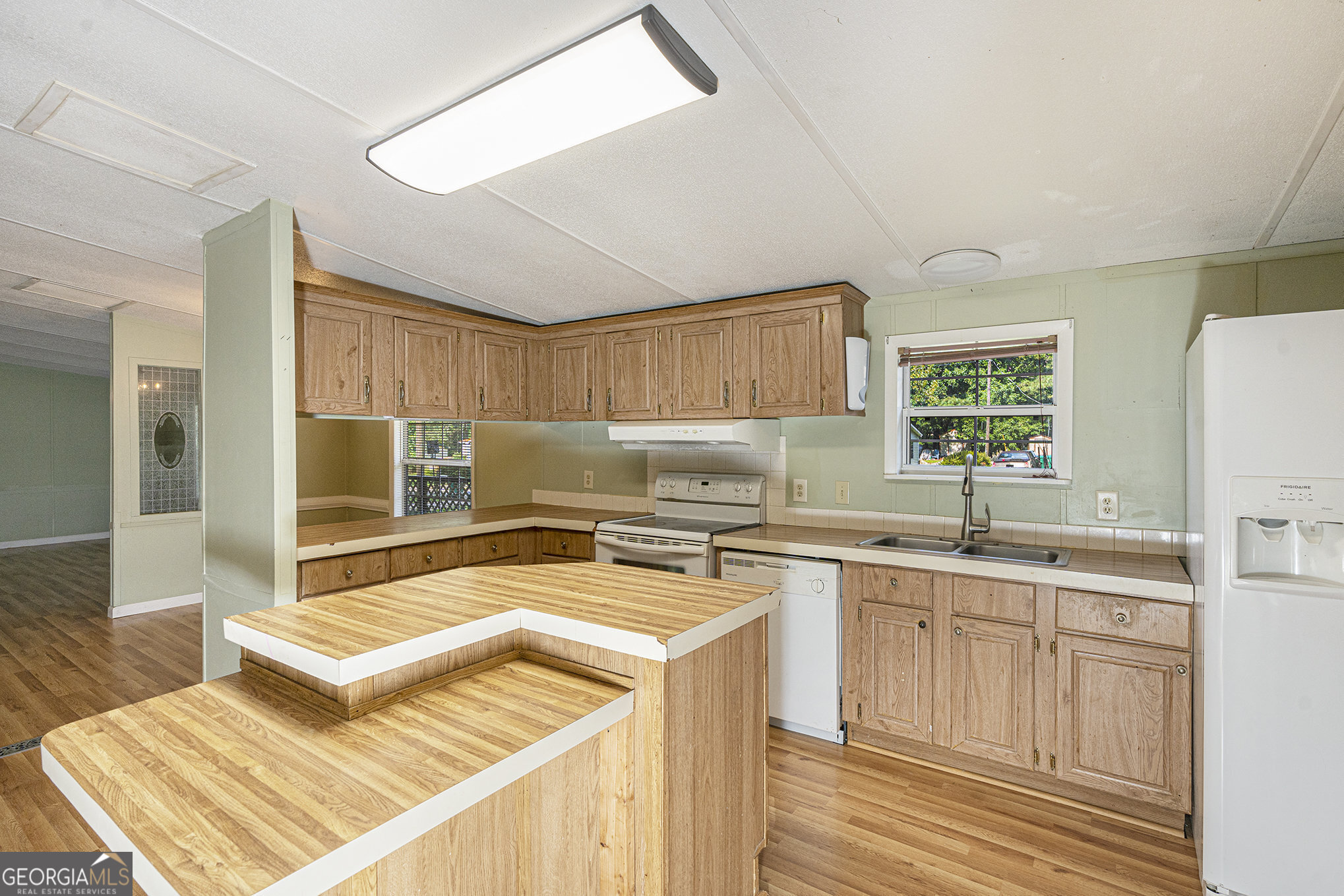 340 Loblolly Ridge Locust Grove, GA 30248 - Photo 9 of 26 a kitchen with a sink a stove and cabinets
