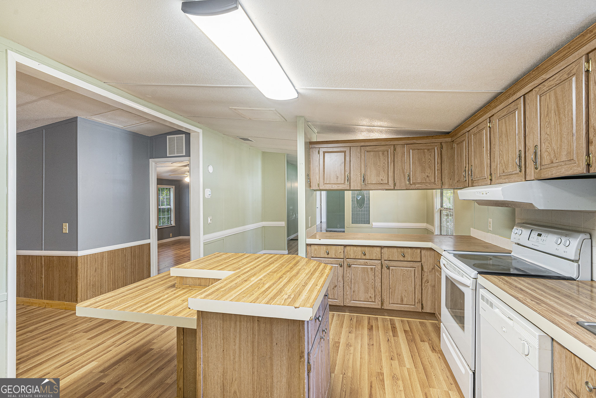 340 Loblolly Ridge Locust Grove, GA 30248 - Photo 10 of 26 a kitchen with a sink and wooden floor