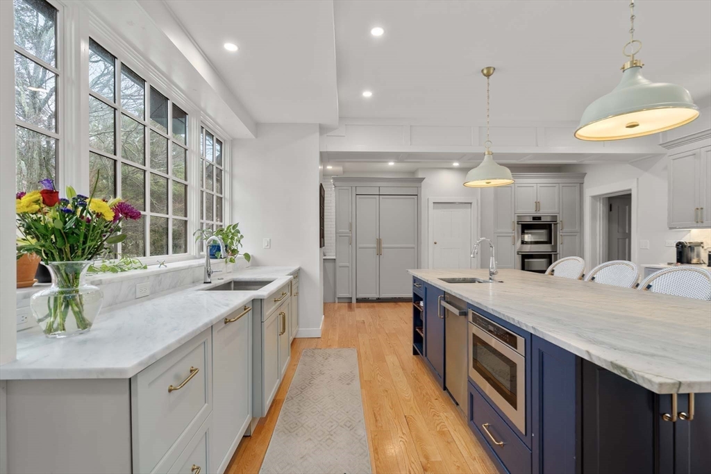 27 Tudor Road Newton, MA 02467 - Photo 3 of 42 a large kitchen with kitchen island a sink and a stove