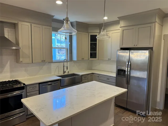 a kitchen with a stove a refrigerator and a sink