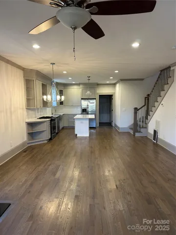a view of kitchen with cabinets and wooden floor
