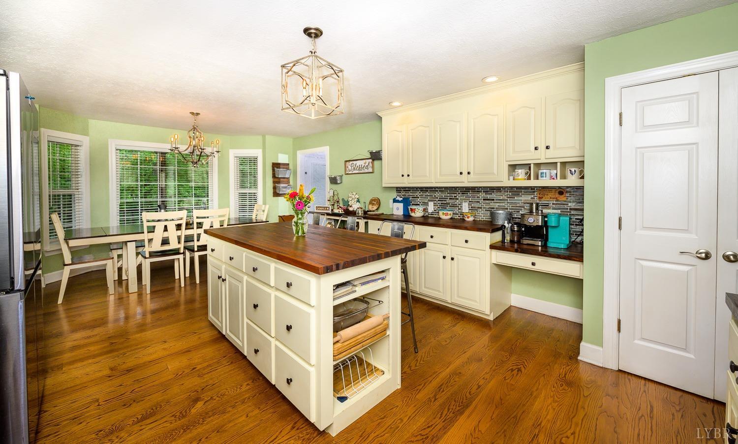 149 Locust Street Amherst, VA 24521 - Photo 17 of 86 a kitchen with wooden cabinets and a stove