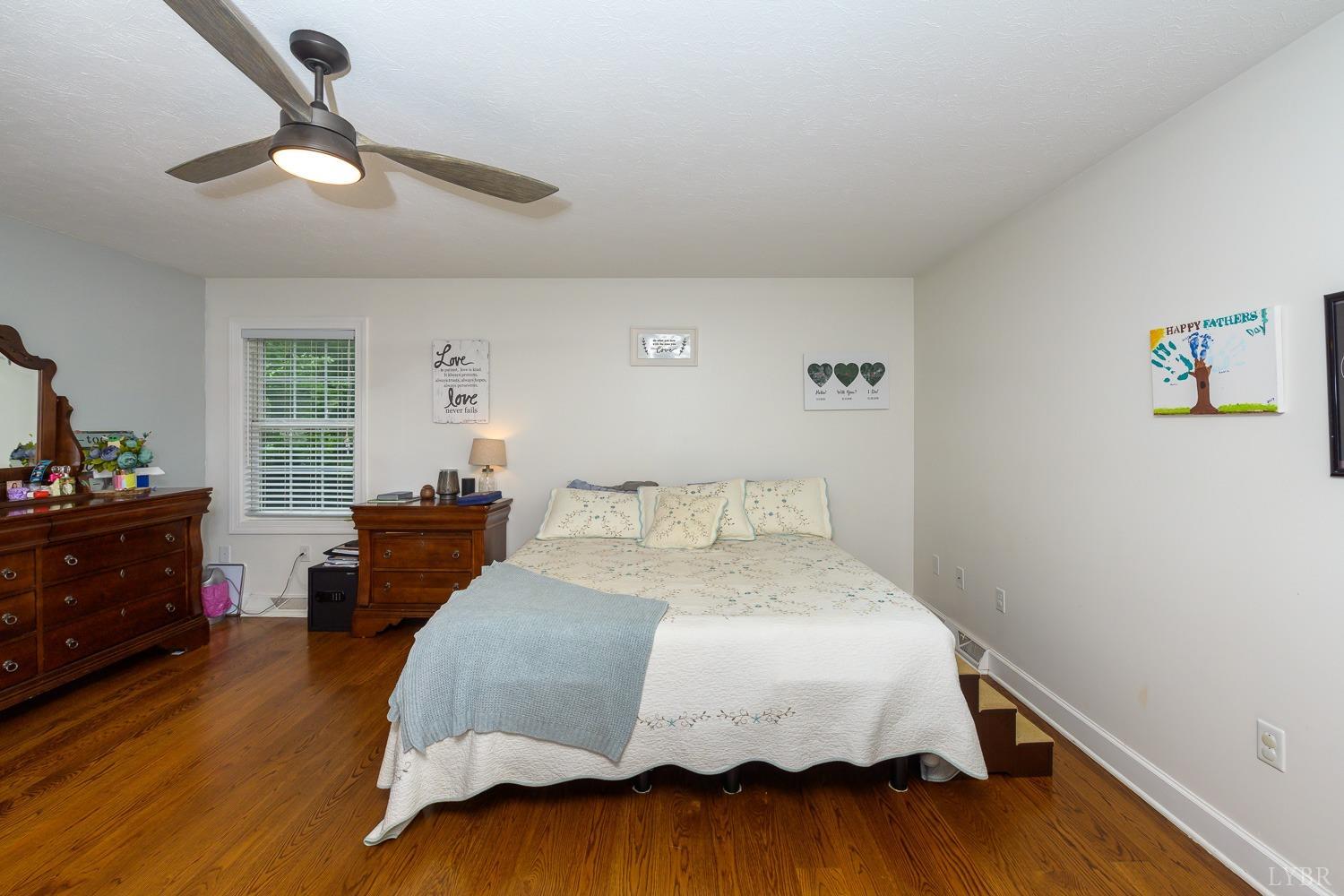 149 Locust Street Amherst, VA 24521 - Photo 32 of 86 a bedroom with a bed and wooden floor