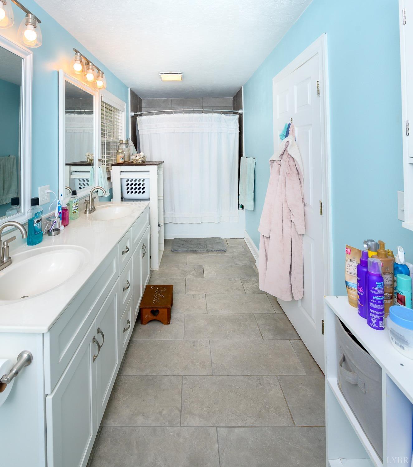 149 Locust Street Amherst, VA 24521 - Photo 33 of 86 a bathroom with a double vanity sink mirror and shower