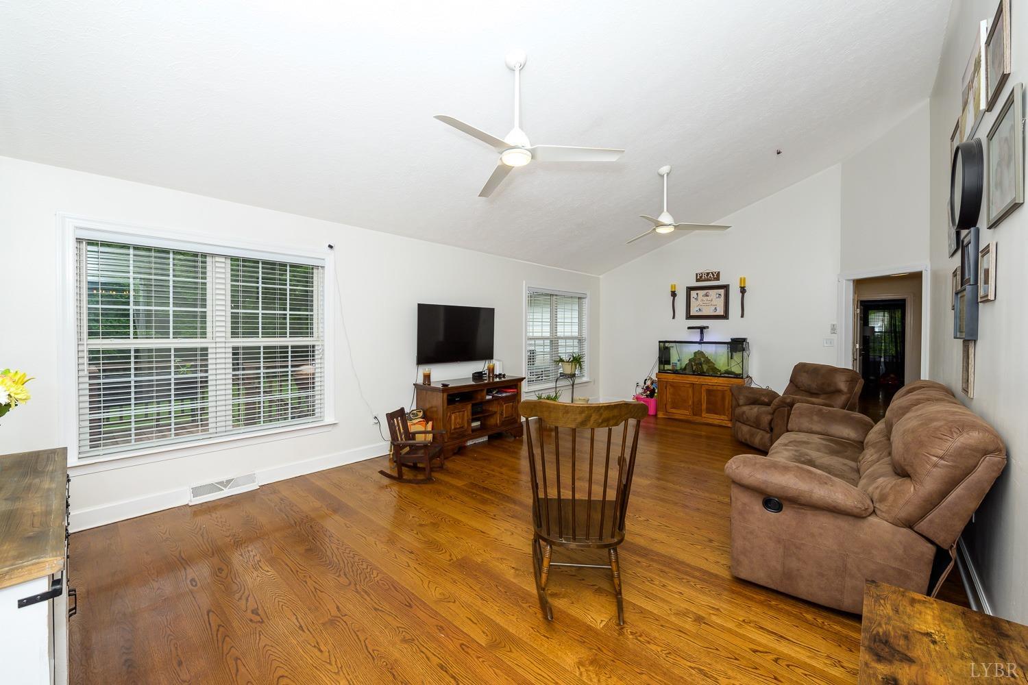 149 Locust Street Amherst, VA 24521 - Photo 42 of 86 a living room with furniture a fireplace and a flat screen tv