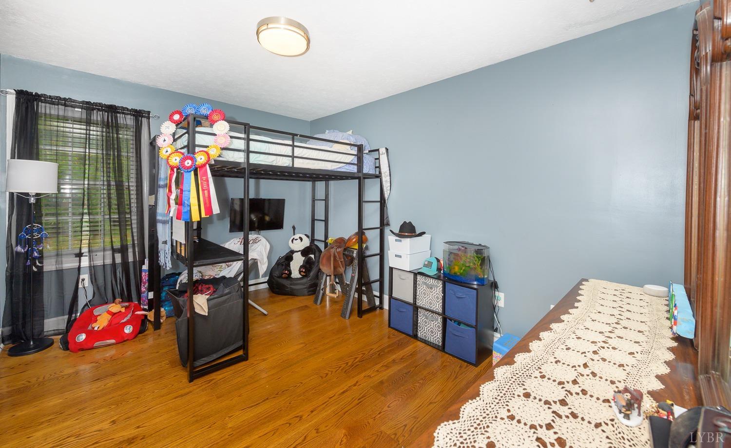 149 Locust Street Amherst, VA 24521 - Photo 45 of 86 a bedroom with furniture and a flat screen tv