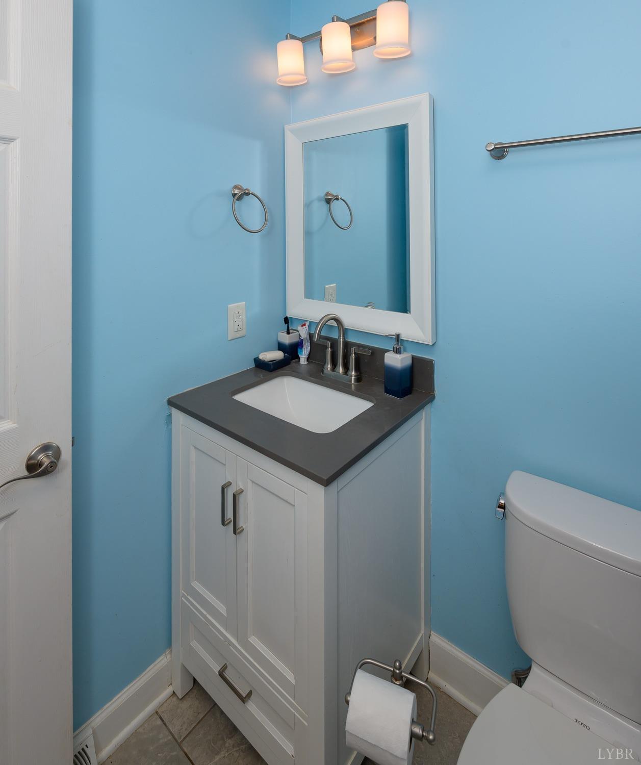 149 Locust Street Amherst, VA 24521 - Photo 49 of 86 a bathroom with a granite countertop toilet and a sink