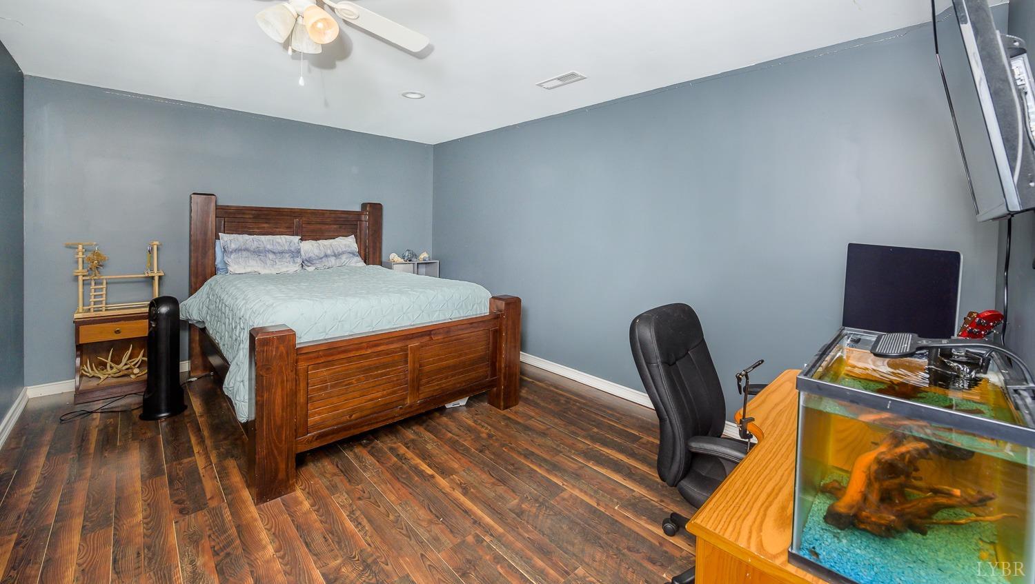 149 Locust Street Amherst, VA 24521 - Photo 50 of 86 a bedroom with a bed and a chair