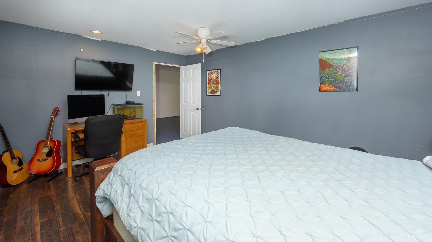 149 Locust Street Amherst, VA 24521 - Photo 51 of 86 a bedroom with a bed and a flat screen tv