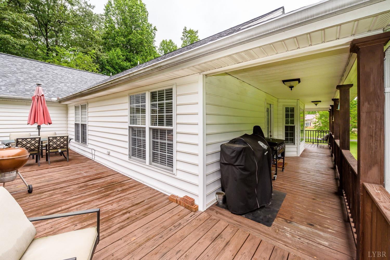 149 Locust Street Amherst, VA 24521 - Photo 60 of 86 a view of a balcony with chairs and wooden floor