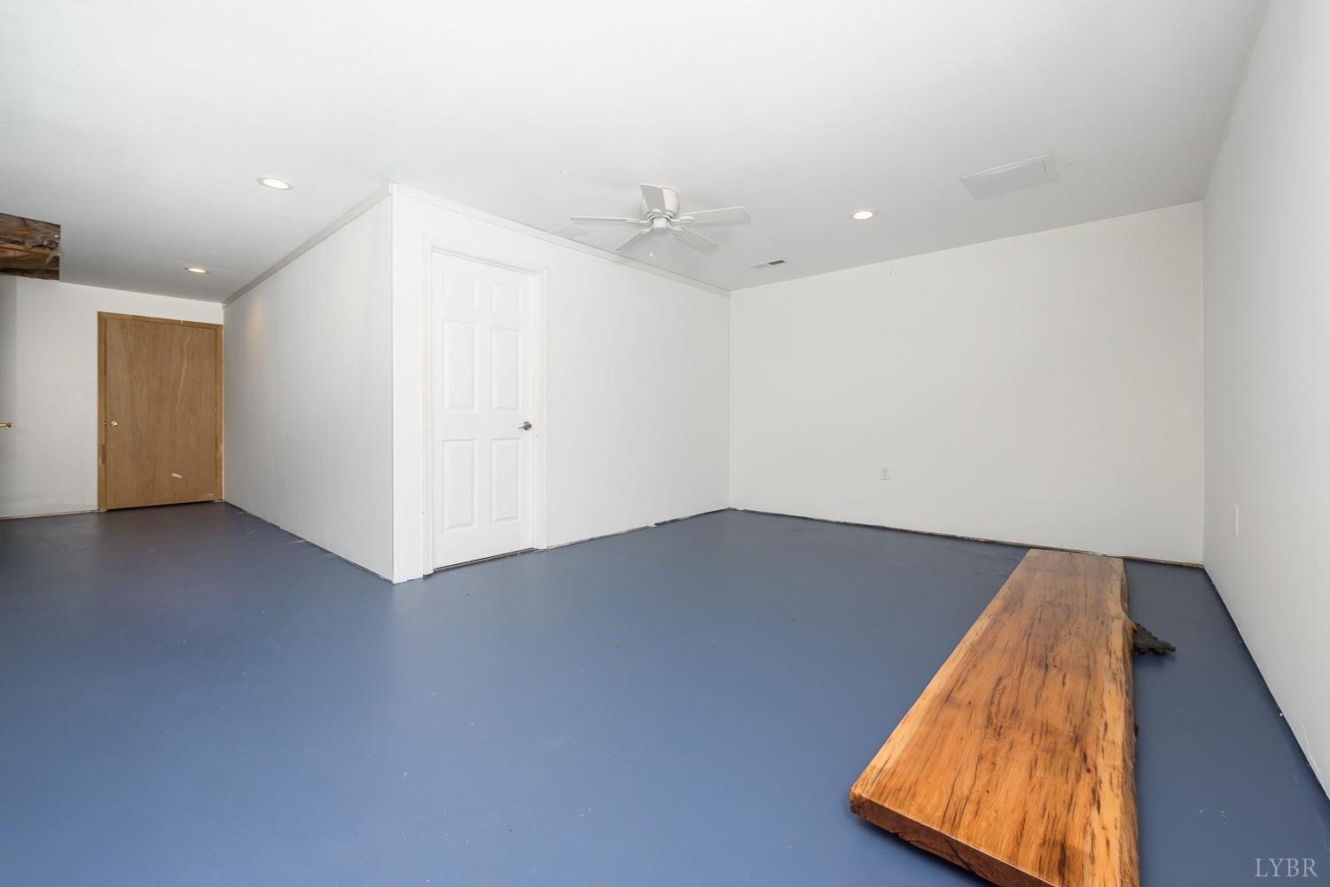 149 Locust Street Amherst, VA 24521 - Photo 73 of 86 an empty room with wooden floor and fan