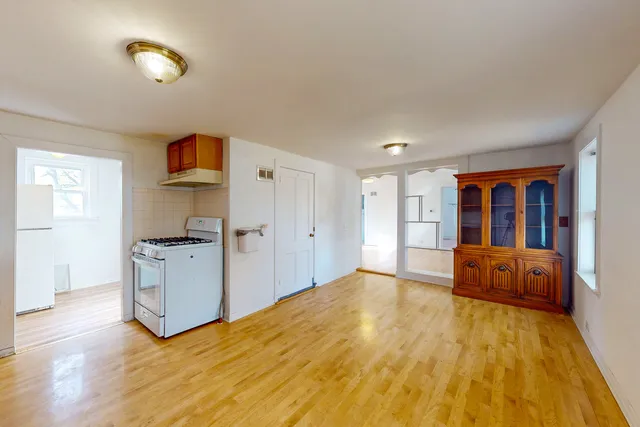 a bedroom with a bed and a view of kitchen