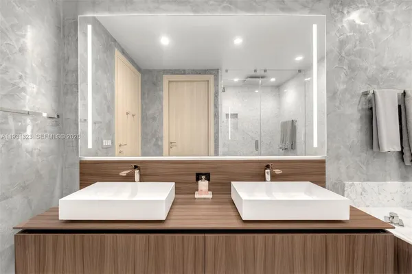a bathroom with a double vanity sink and a mirror