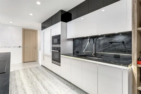 a kitchen with stainless steel appliances a refrigerator and microwave