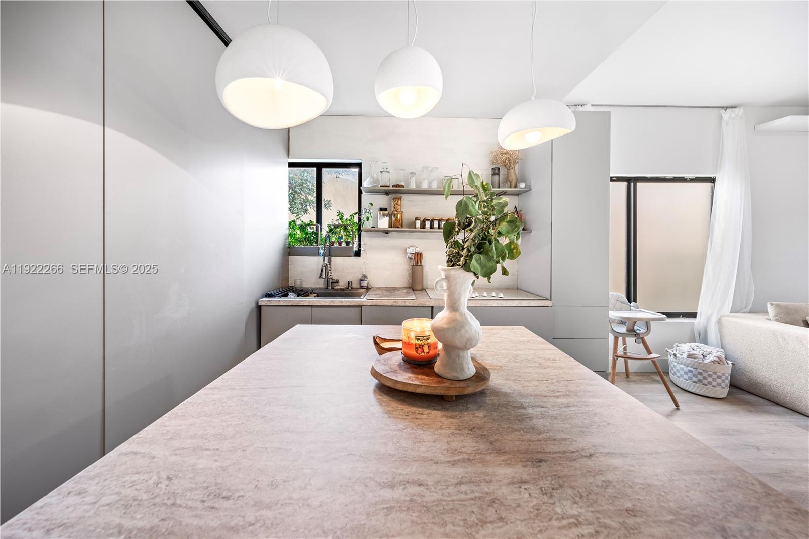 1910 Northwest 47th Street Miami, FL 33142 - Photo 13 of 32 a living room with furniture and a chandelier