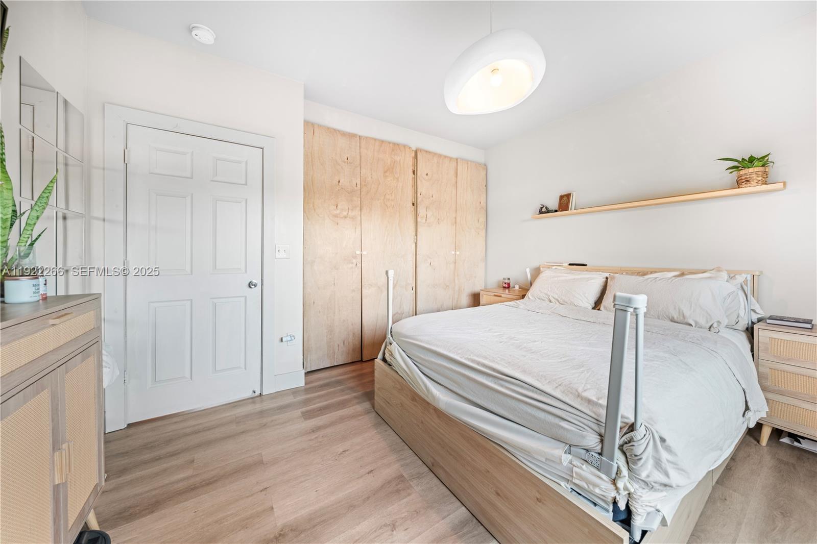 1910 Northwest 47th Street Miami, FL 33142 - Photo 24 of 32 a bedroom with a bed and a chandelier