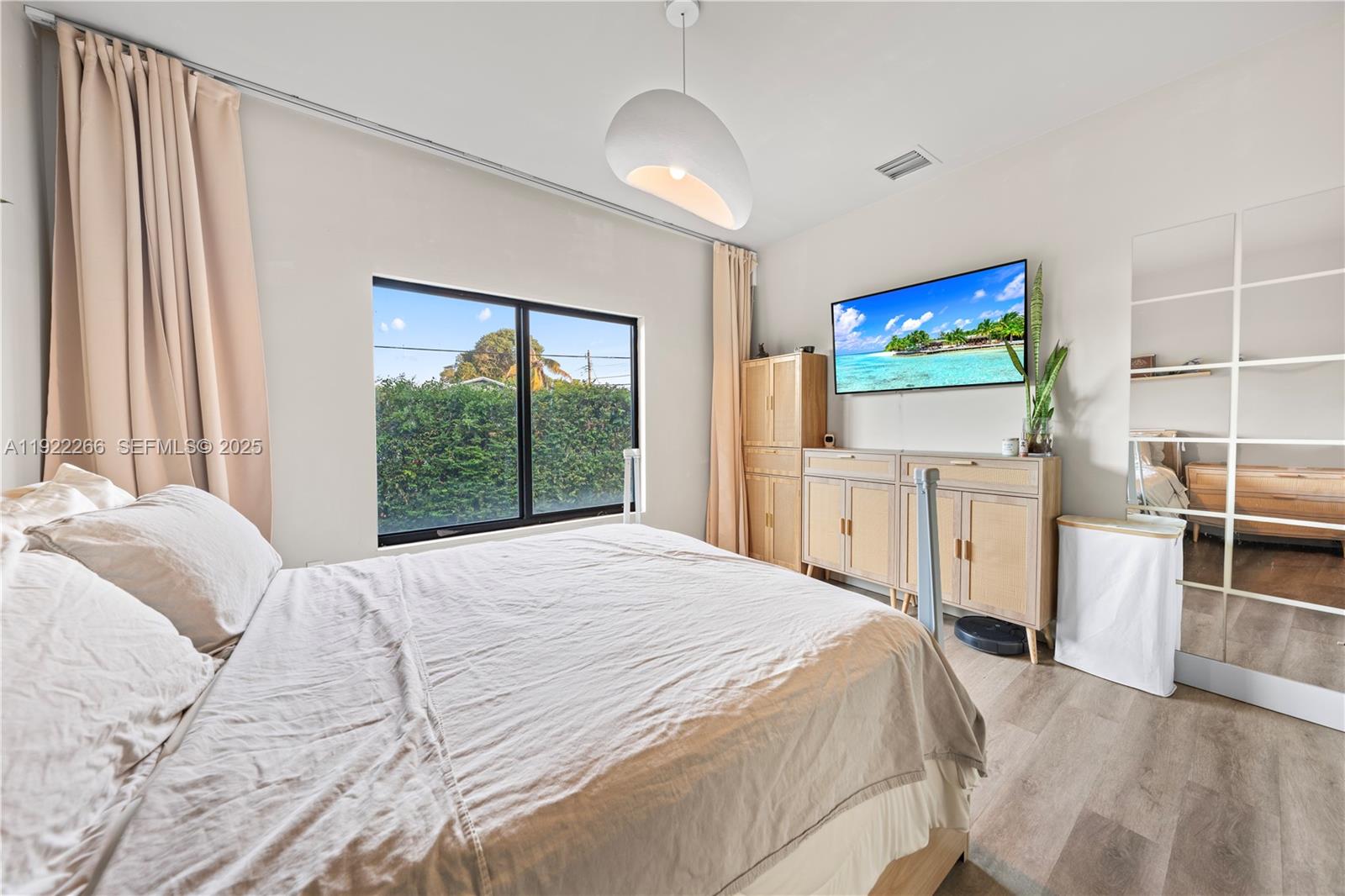 1910 Northwest 47th Street Miami, FL 33142 - Photo 25 of 32 a bedroom with a bed and a flat screen tv