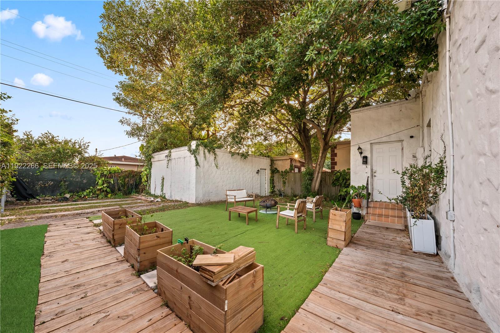 1910 Northwest 47th Street Miami, FL 33142 - Photo 30 of 32 a front view of a house with garden and patio