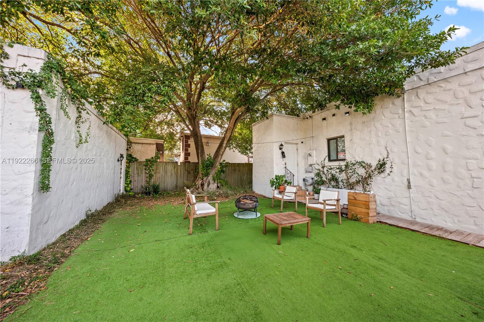 1910 Northwest 47th Street Miami, FL 33142 - Photo 32 of 32 a backyard of a house with outdoor seating