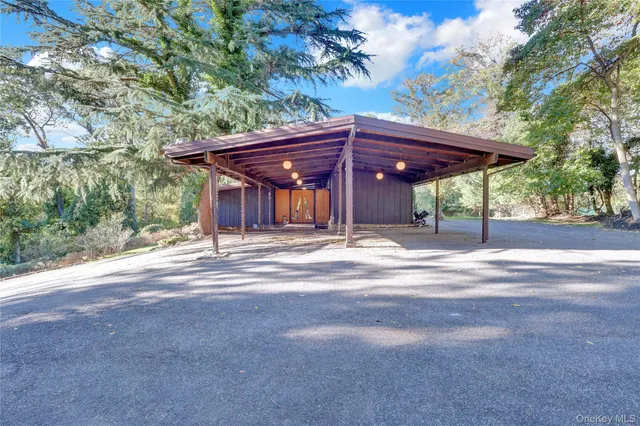 a view of a wooden house with a large tree