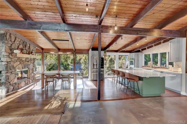 a dining room with furniture wooden floor and a rug